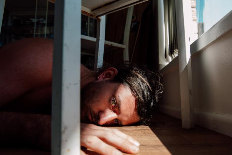 Self-portrait of photographer, Warwick Gow, lying on the ground