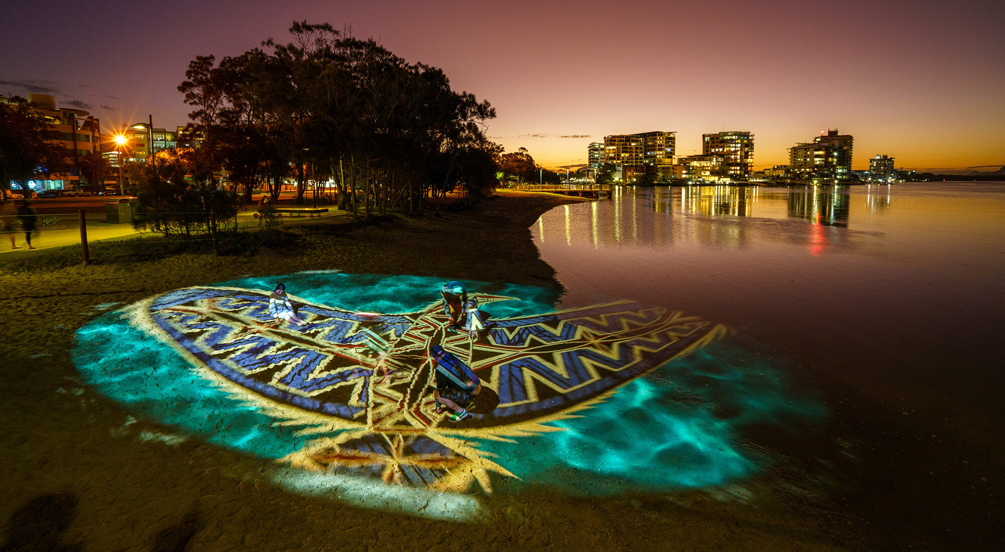 First Nation artwork projected onto the sand.