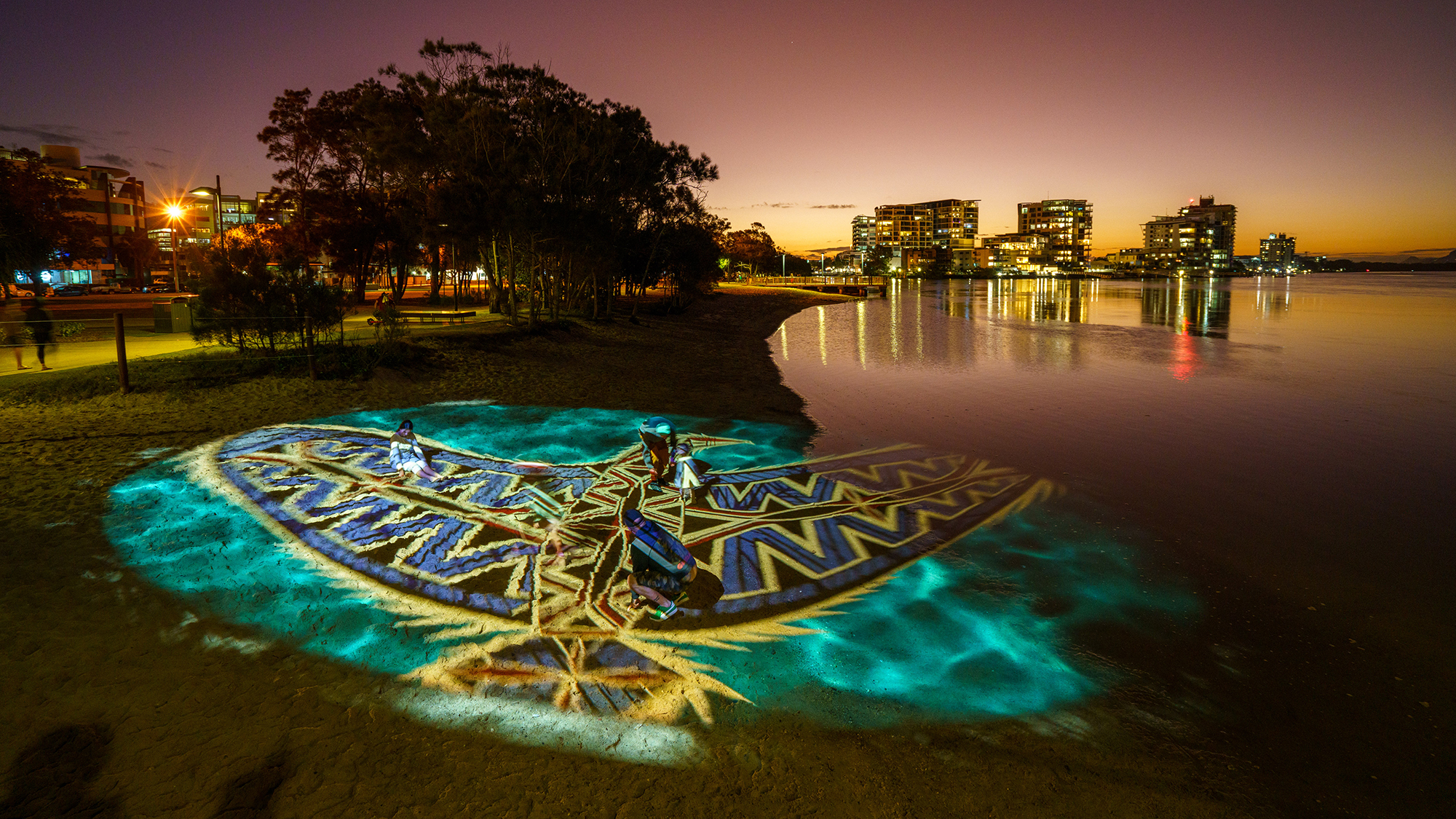 First Nation artwork projected onto the sand.