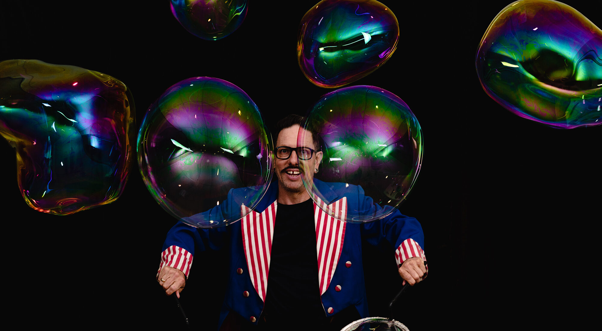 A person stood behind bubbles.