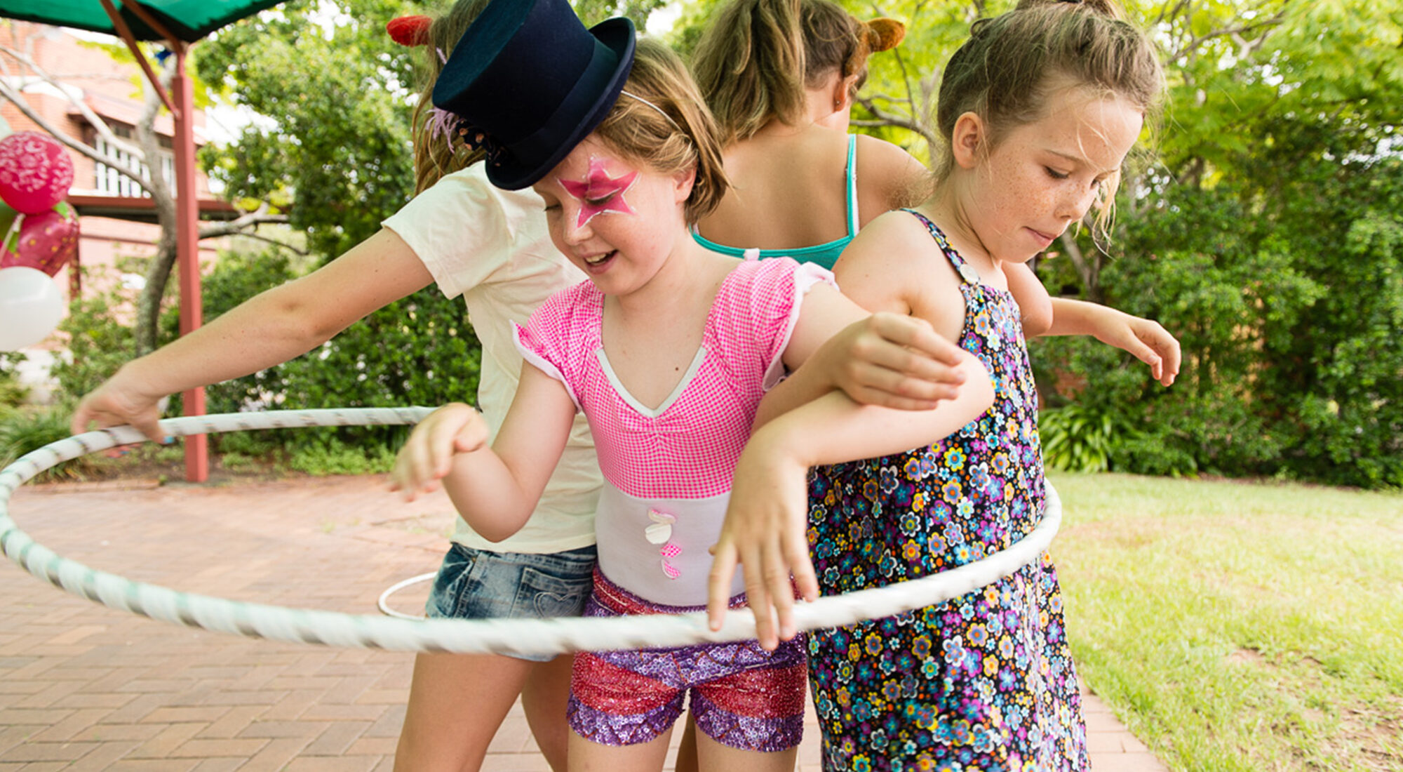 children playing with a hula-hoop.