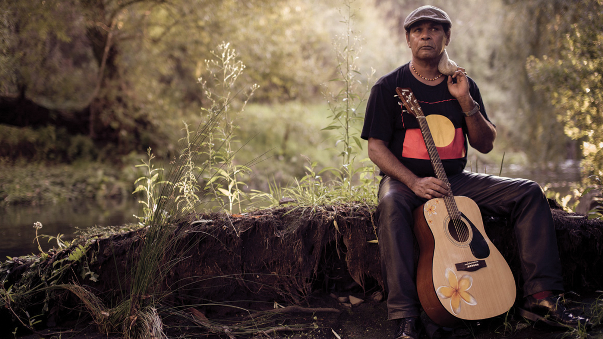 A First Nations musician and a guitar.